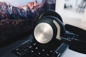 A photo of some headphones resting on a keyboard
