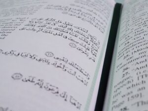 An book with Arabic text on the left-hand page, and English text on the right-hand page