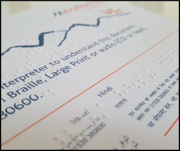 A compliment slip with alternative formats and languages statement, embossed with Braille.