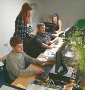 A photo of Will, with Marianne, Liam Susie in the A2i offices