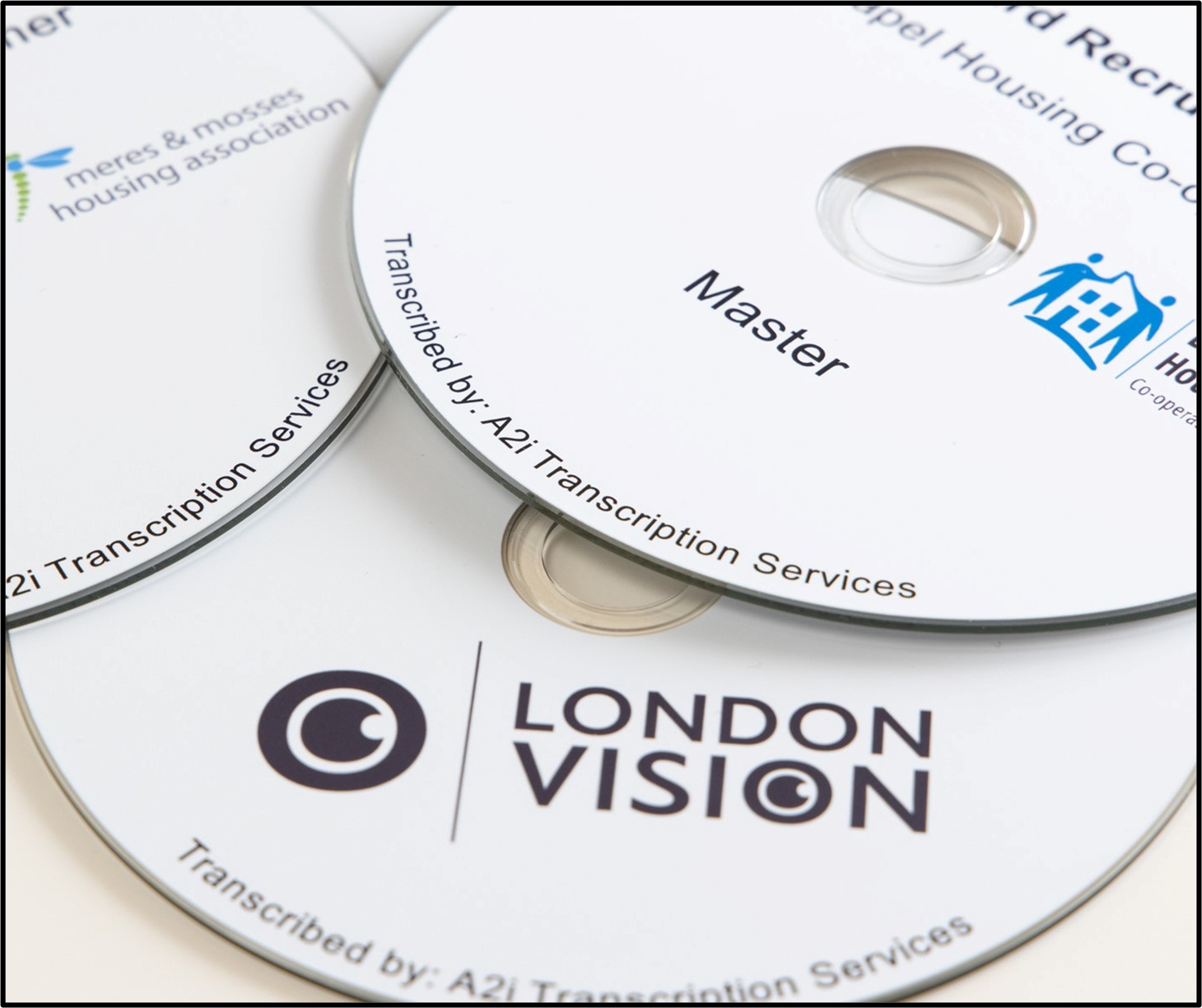 Image of several standard Audio CD's with black text and colourful logos on white backgrounds