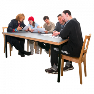 Group of adults with a learning disability around a table looking at Easy Read documents