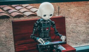 Robot sat on a bench and using a digital tablet