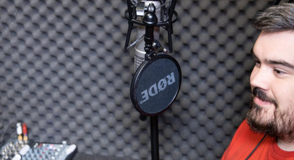 A male transcriber recording audio.